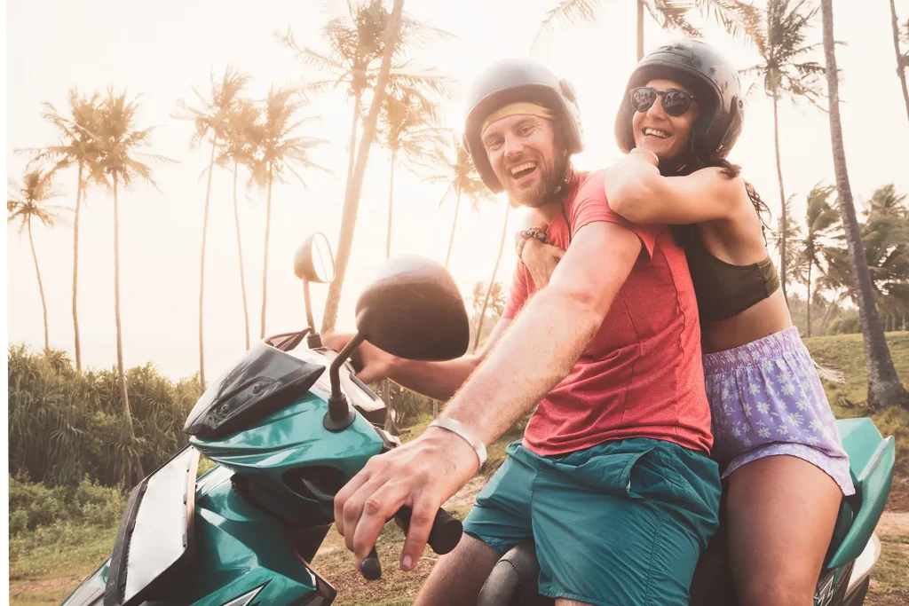 couple riding scooter on coastal road sri lanka