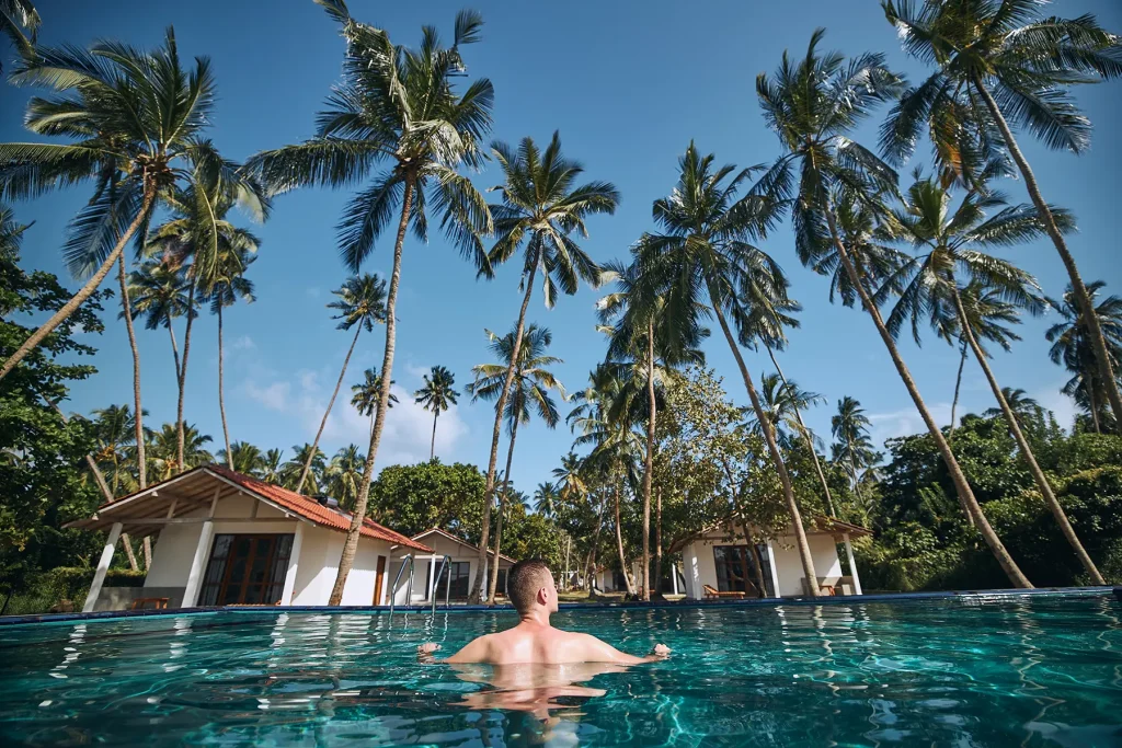 relaxing in villa pool with palm trees sri lanka