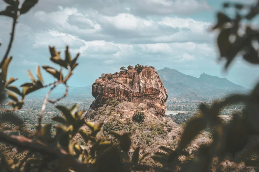 view of sigiriya rock framed by leaves