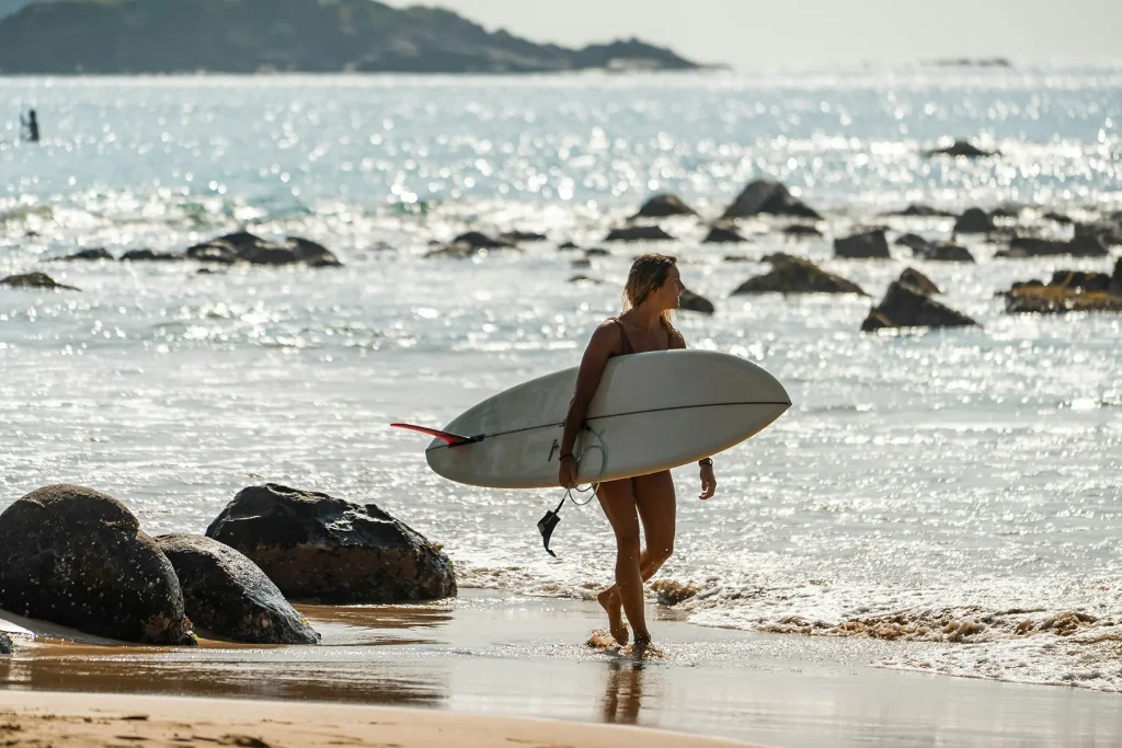 woman surfing at weligama beach sri lanka