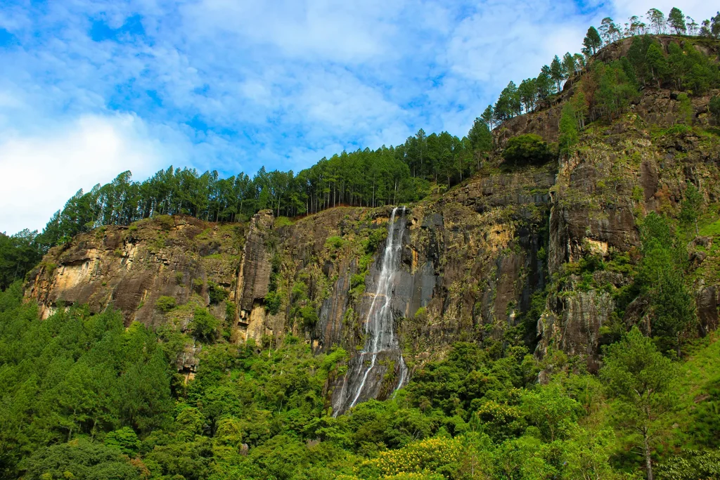 Bambarakanda Waterfall cascading down a rocky cliff, a breathtaking natural wonder that is one of Sri Lanka's Hidden Gems.